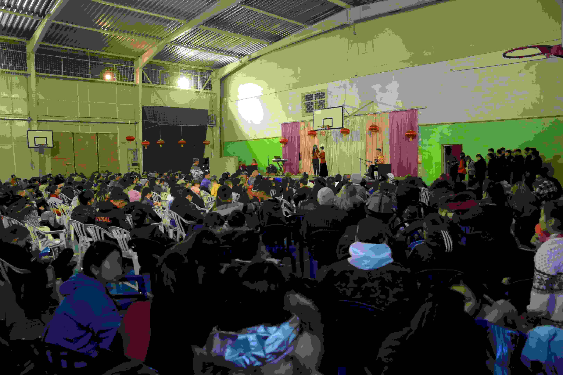 Large crowd gathered in a hall during an outreach gathering